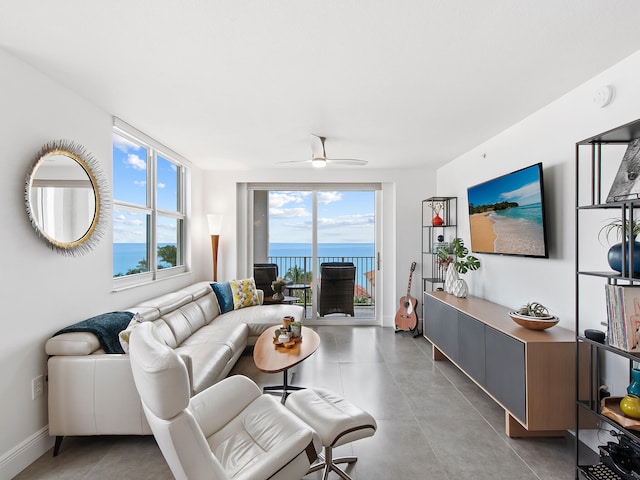 living room with ceiling fan and a healthy amount of sunlight