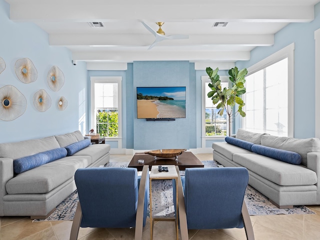 living room with ceiling fan, beam ceiling, and light tile patterned floors