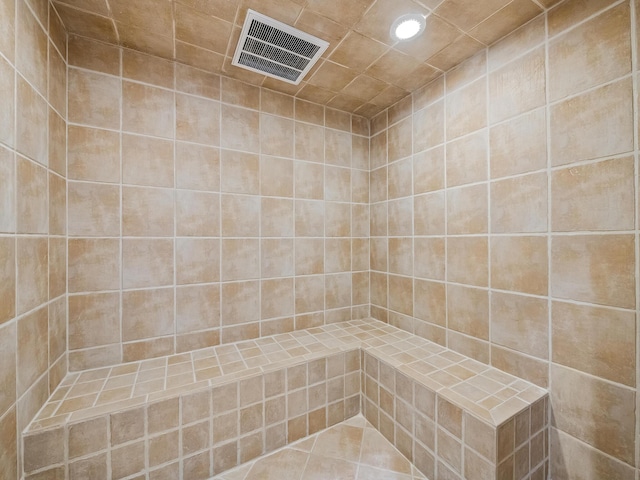 bathroom with a tile shower