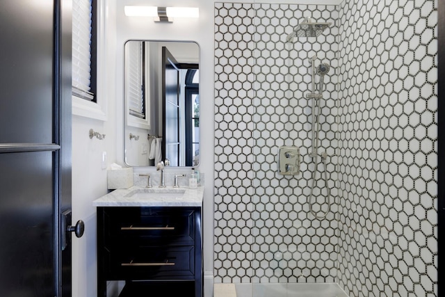 bathroom featuring vanity and tiled shower