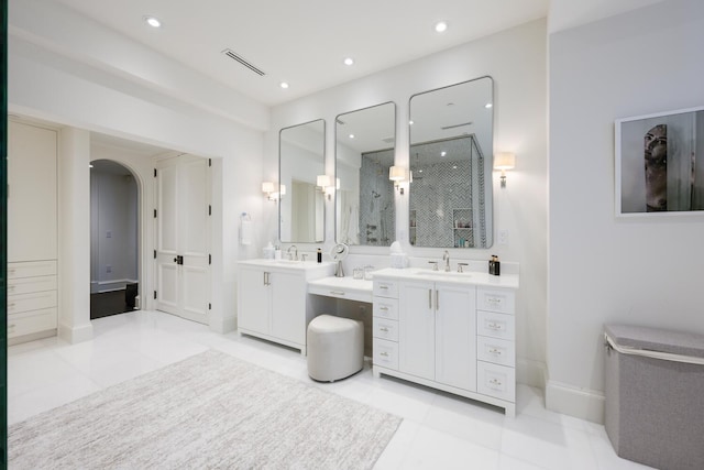 bathroom featuring vanity, a shower, and tile patterned floors