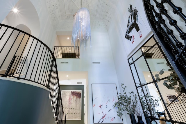 staircase with a towering ceiling