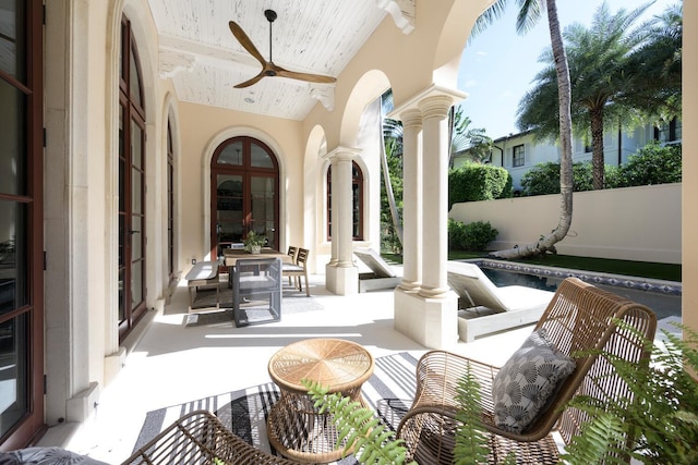 view of patio / terrace featuring french doors, ceiling fan, and a pool