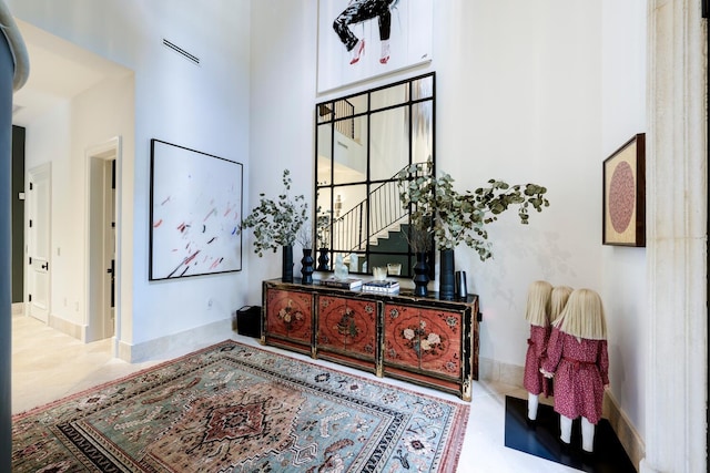 hallway featuring a high ceiling