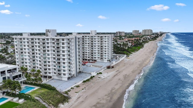 drone / aerial view featuring a water view and a beach view