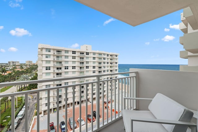 balcony featuring a water view and a beach view