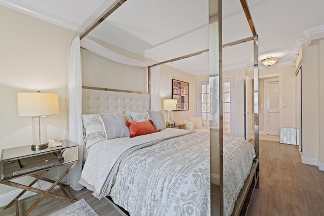 bedroom featuring crown molding and hardwood / wood-style flooring