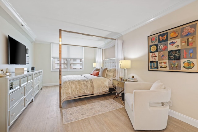 bedroom featuring light hardwood / wood-style floors and crown molding