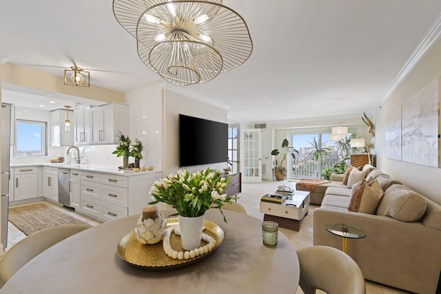 living room with crown molding, an inviting chandelier, and plenty of natural light