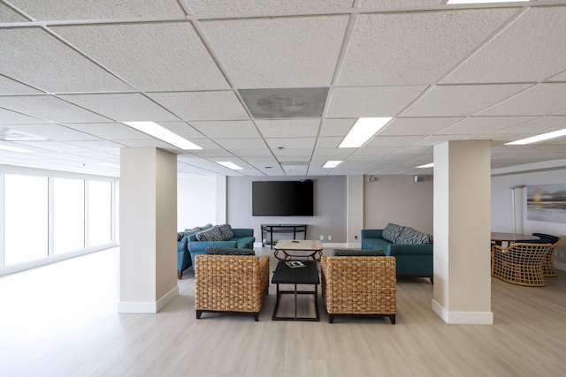 interior space with hardwood / wood-style flooring and a drop ceiling