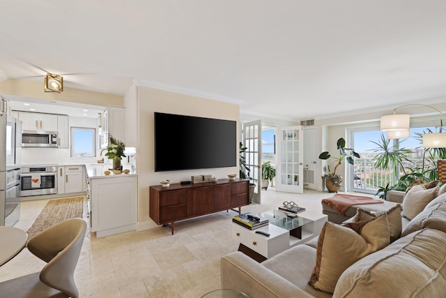 living room featuring french doors and ornamental molding