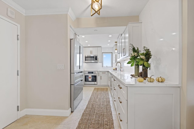 kitchen with light tile patterned floors, appliances with stainless steel finishes, white cabinetry, crown molding, and sink