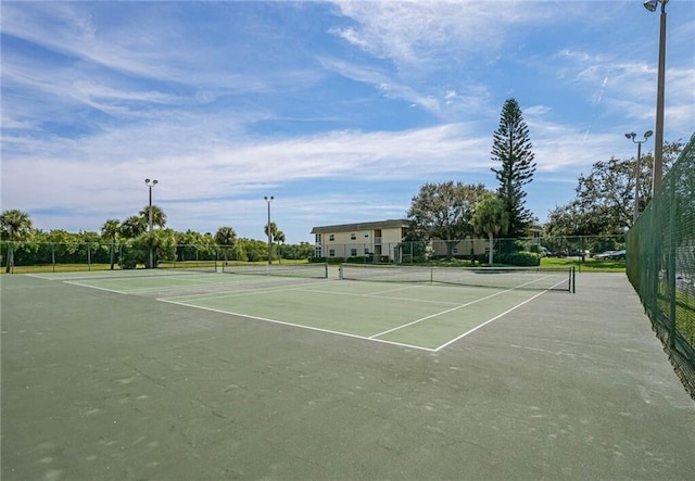 view of sport court featuring fence