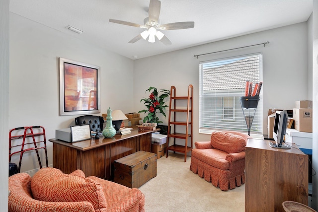 home office featuring light carpet and ceiling fan