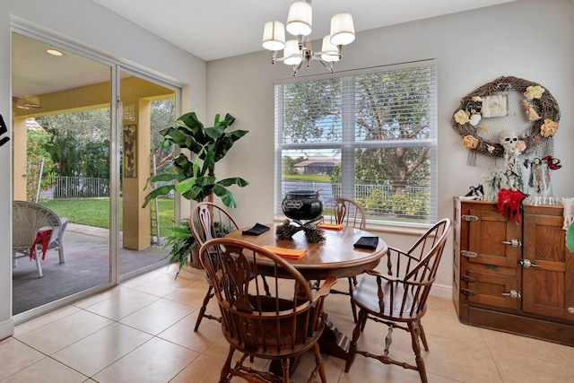 tiled dining space with an inviting chandelier and a healthy amount of sunlight