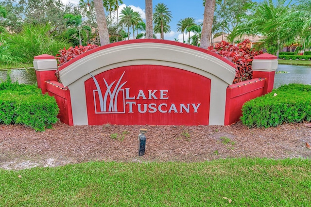 community sign featuring a water view