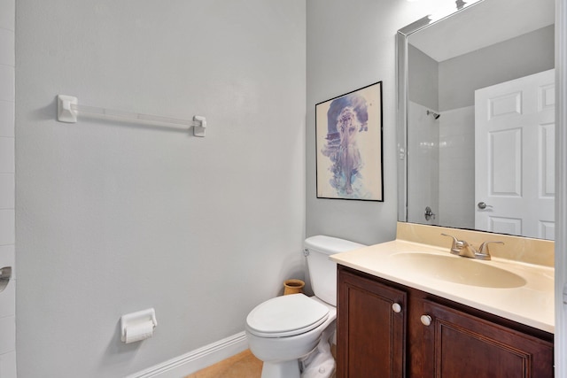 bathroom with vanity, tile patterned flooring, toilet, and walk in shower