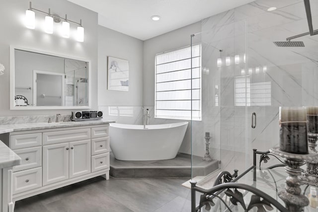 bathroom featuring vanity, tile walls, separate shower and tub, and concrete flooring