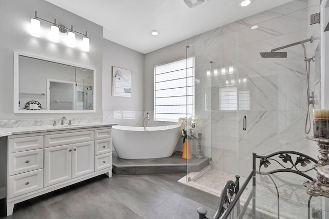 bathroom with concrete floors, a textured ceiling, tile walls, vanity, and plus walk in shower