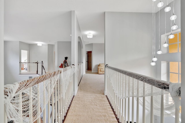 hallway featuring light colored carpet