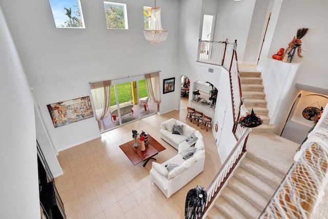 living room featuring a chandelier and a high ceiling