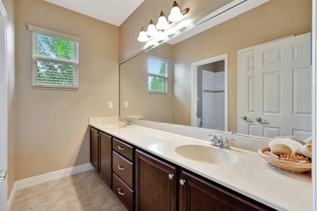 bathroom featuring vanity, toilet, plenty of natural light, and tile patterned flooring