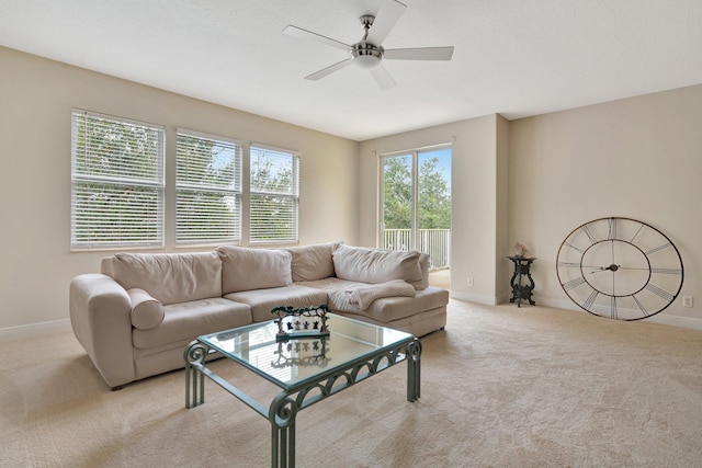 carpeted living room featuring ceiling fan