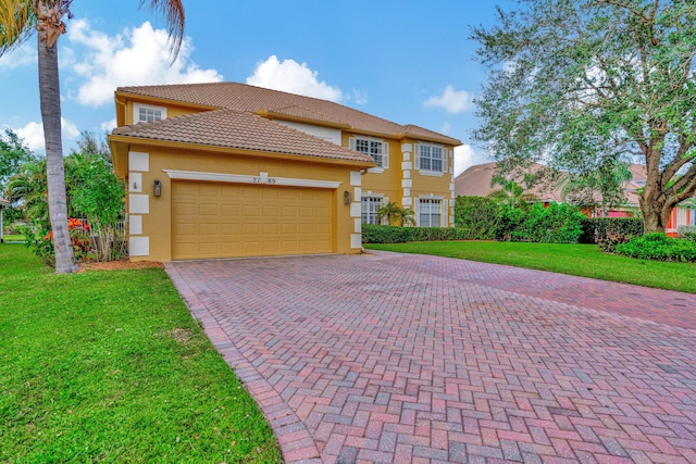 view of front of home featuring a front yard and a garage