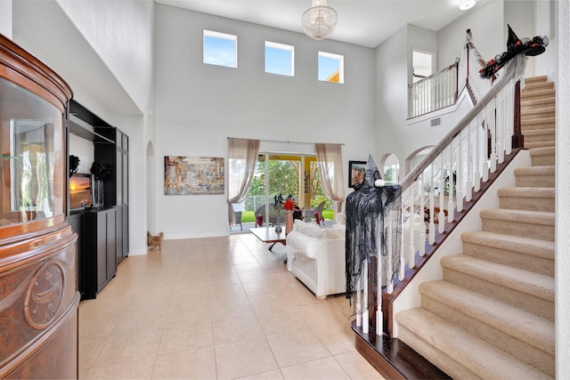 foyer featuring a high ceiling and light tile patterned floors