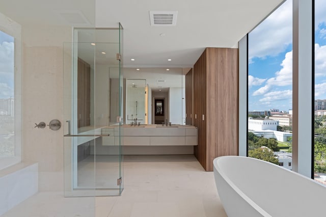 bathroom featuring vanity, a wall of windows, and plus walk in shower