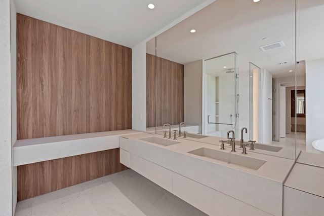 bathroom with vanity and a shower with shower door