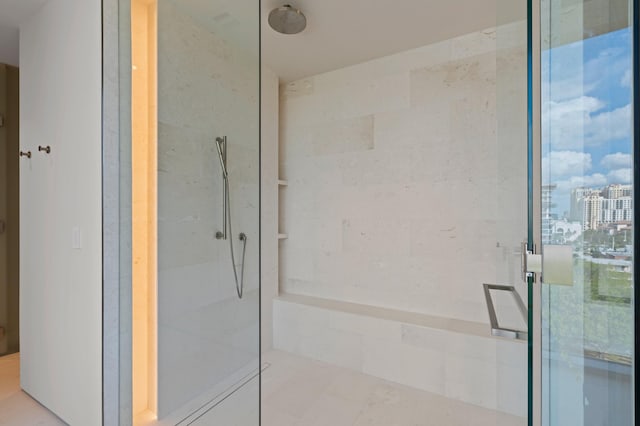 bathroom with a shower with door