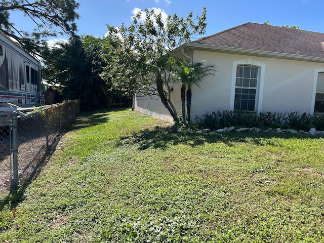 view of property exterior featuring a lawn and a sunroom