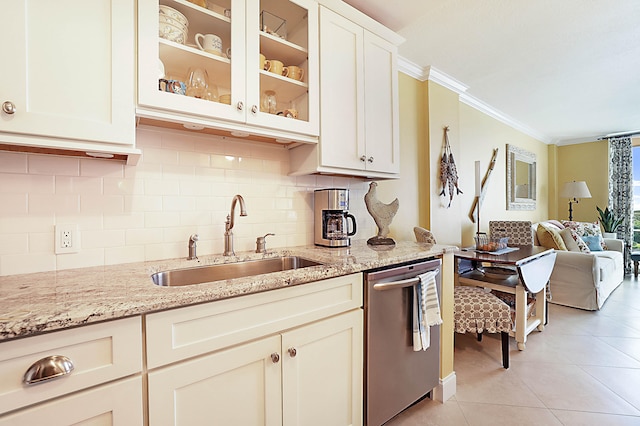 kitchen featuring crown molding, light tile patterned floors, glass insert cabinets, a sink, and dishwasher