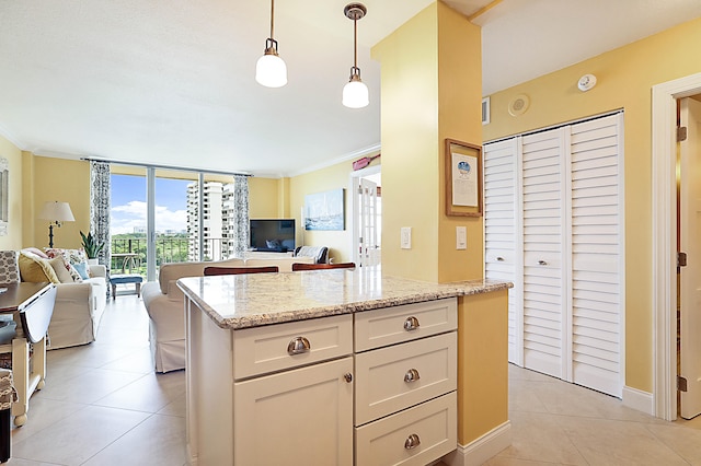 kitchen with open floor plan, light tile patterned floors, a wall of windows, and ornamental molding