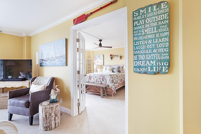 bedroom featuring light tile patterned flooring, crown molding, and baseboards