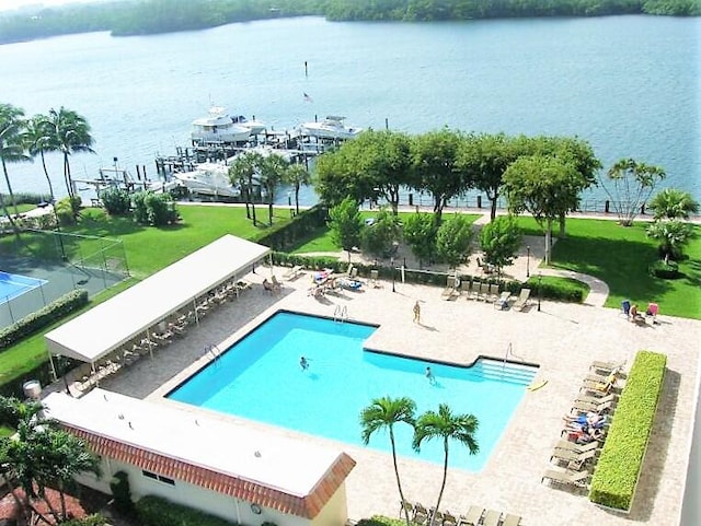 community pool with a water view and a patio area