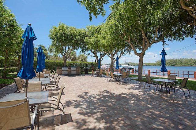 view of patio / terrace featuring outdoor dining space and a water view