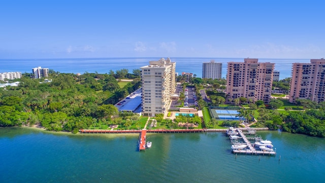 birds eye view of property featuring a water view and a city view