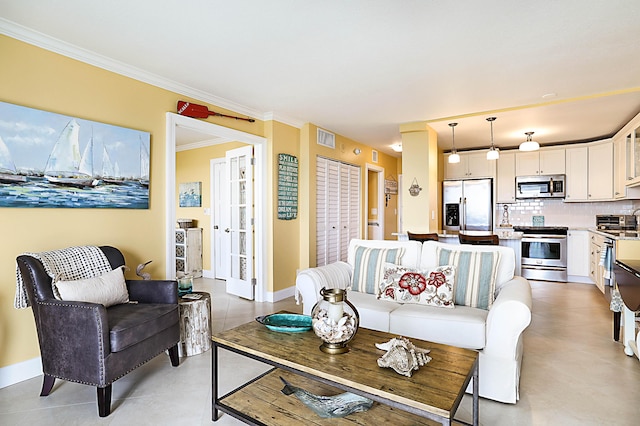 living room featuring baseboards, visible vents, and ornamental molding