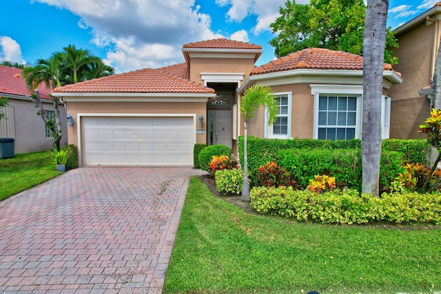 view of front of home featuring a front yard and a garage