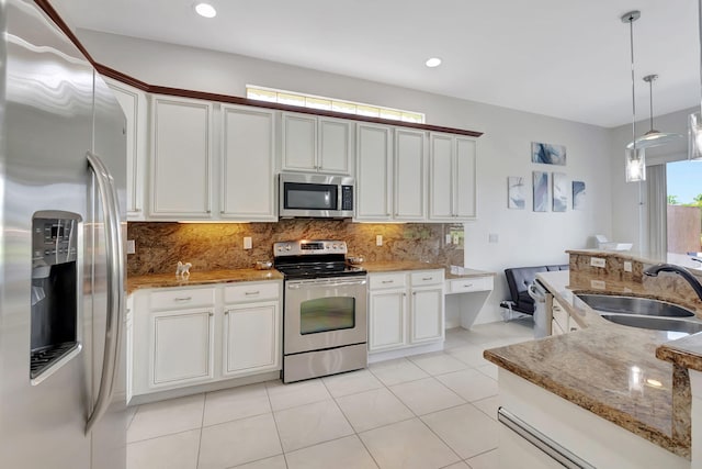 kitchen with white cabinets, appliances with stainless steel finishes, sink, and hanging light fixtures