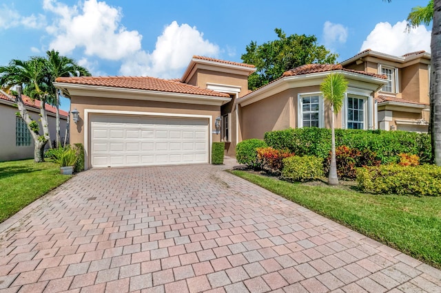 mediterranean / spanish-style house featuring a front lawn and a garage