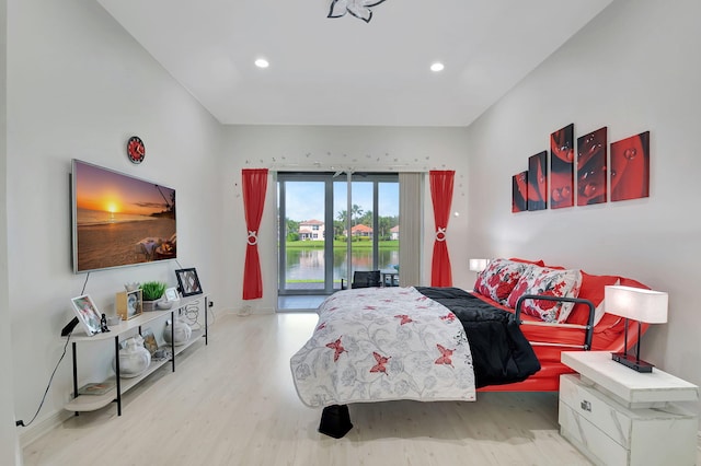 bedroom with light wood-type flooring and access to outside