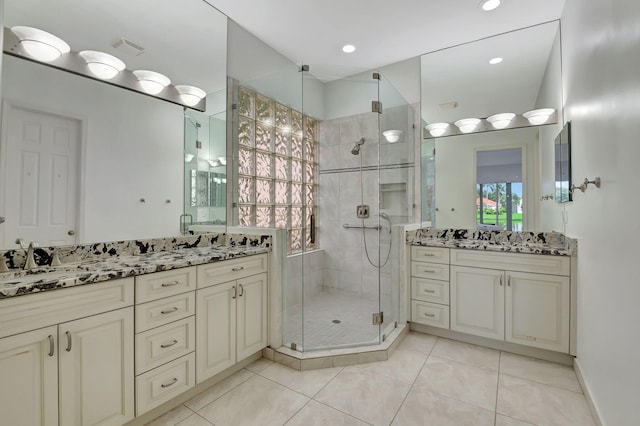 bathroom featuring vanity, tile patterned floors, and an enclosed shower