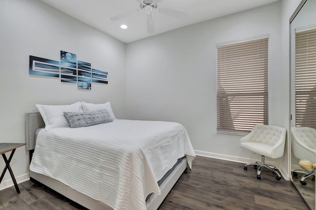 bedroom with dark hardwood / wood-style flooring and ceiling fan