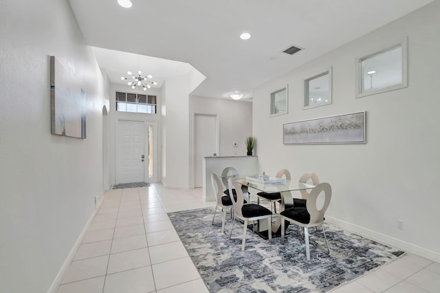 tiled dining room featuring a notable chandelier