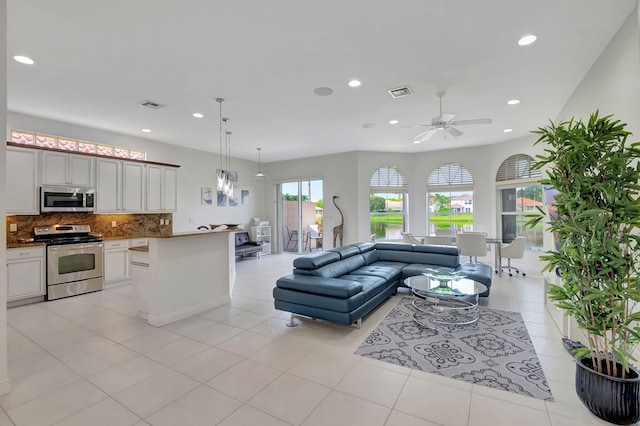 tiled living room featuring ceiling fan