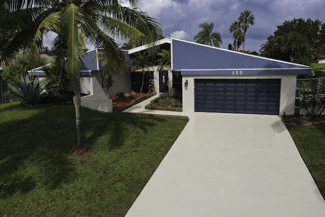 view of front of property with a front yard and a garage