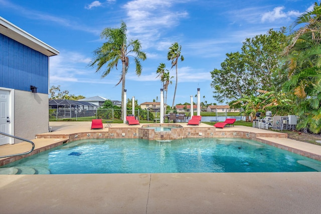 view of swimming pool with an in ground hot tub and a patio